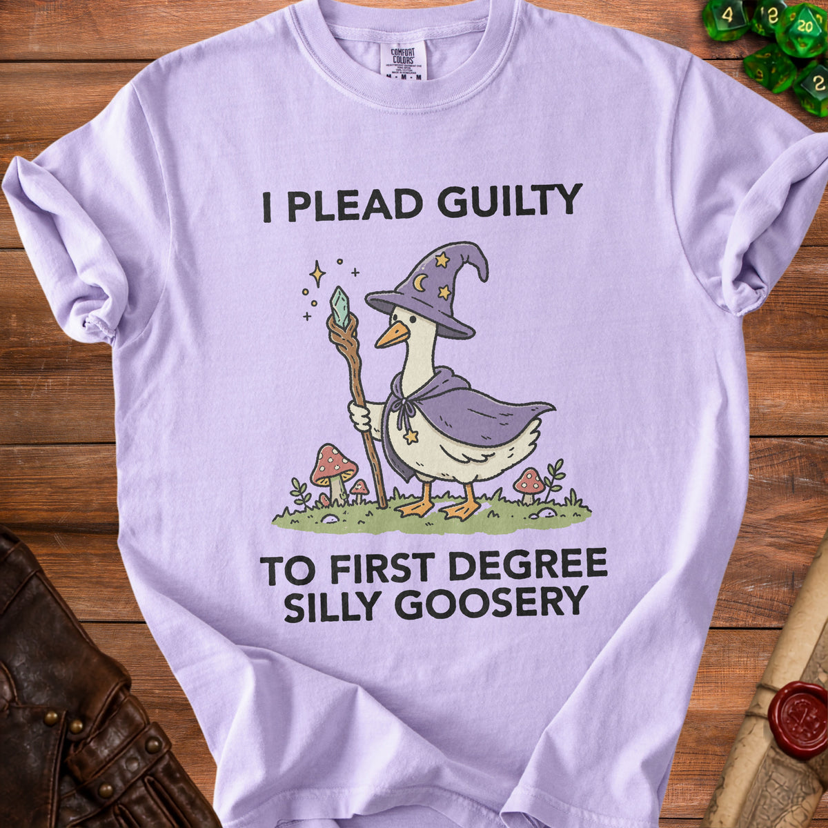 Lavender t-shirt with a goose wearing a wizard hat and robe, holding a staff. Text reads "I PLEAD GUILTY TO FIRST DEGREE SILLY GOOSERY".