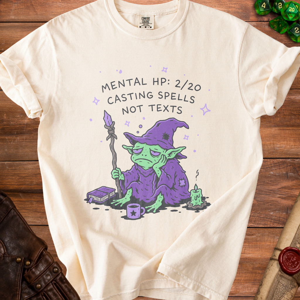 Cream t-shirt with a bored wizard and the text "Mental HP: 2/20 Casting Spells Not Texts."