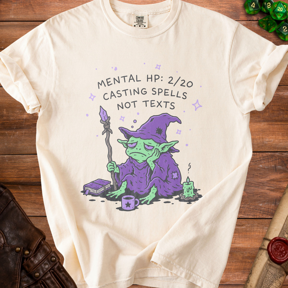 Cream t-shirt with a bored wizard and the text "Mental HP: 2/20 Casting Spells Not Texts."