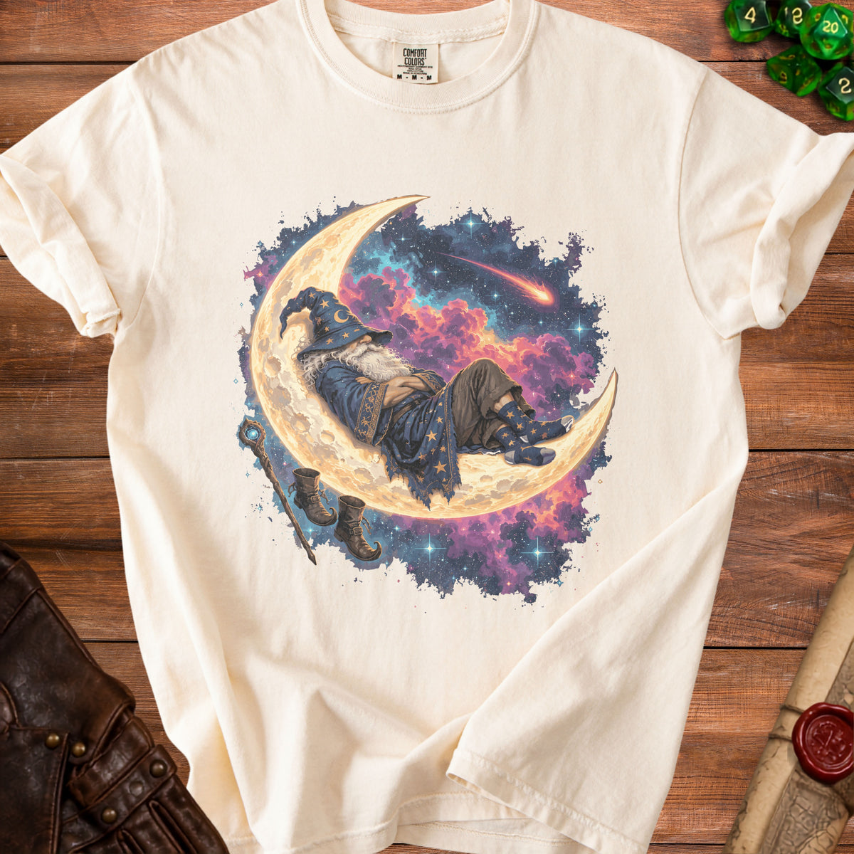 Cream t-shirt with a wizard sleeping on the moon graphic, stars, and clouds.