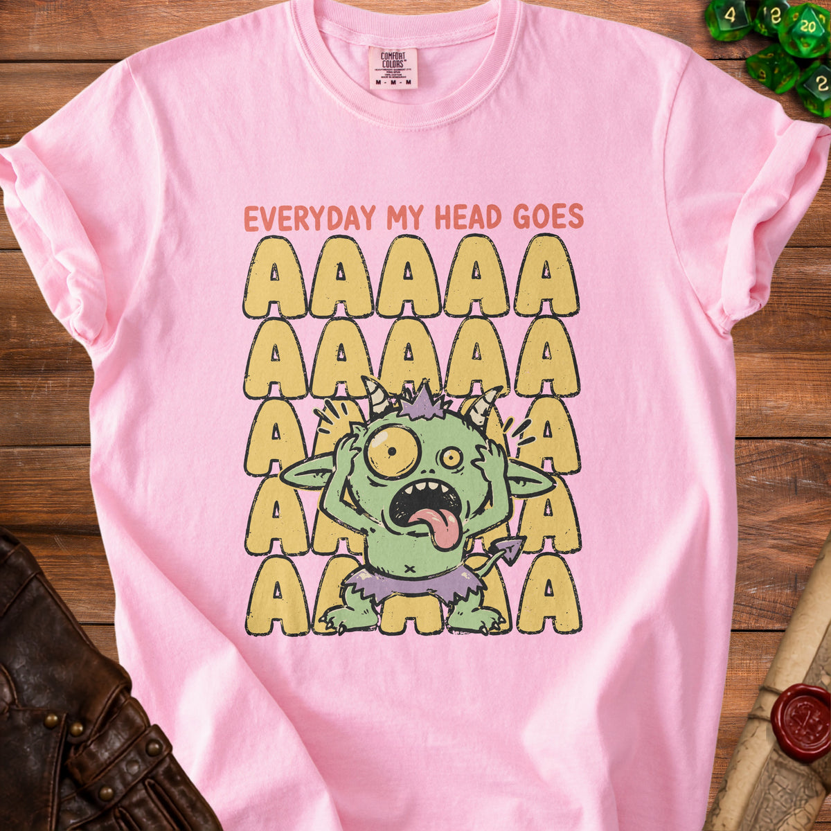 Pink t-shirt with a distressed graphic of a green monster and text "EVERYDAY MY HEAD GOES".
