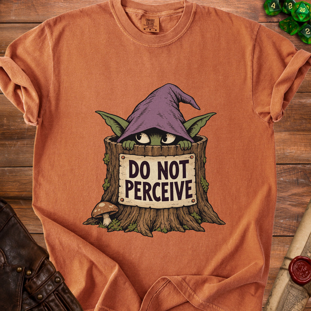 Rust orange t-shirt featuring a green goblin-like creature in a tree stump holding a sign reading DO NOT PERCEIVE.