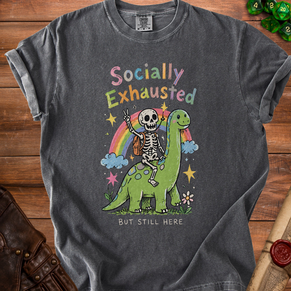 Skeleton riding a dinosaur with "Socially Exhausted But Still Here" text.
