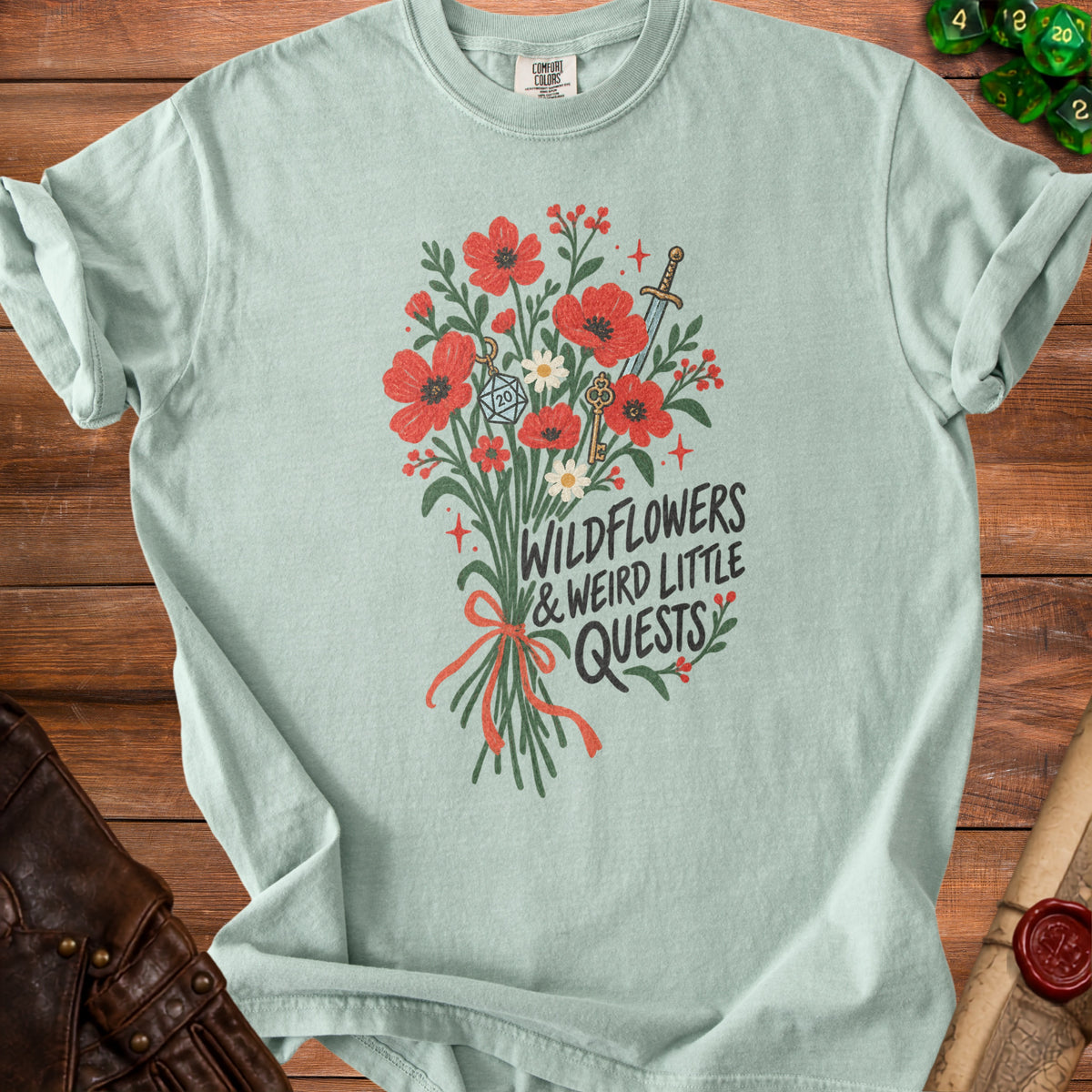 Light blue t-shirt with a floral design, D20 dice, and text.