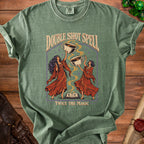 Green t-shirt with "Double Shot Spell Twice The Magic" and two witches holding coffee cups.