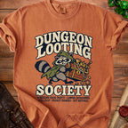Orange t-shirt with a raccoon carrying a treasure chest, text reads Dungeon Looting Society