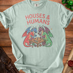 T-shirt with "HOUSES & HUMANS" and dragons playing a board game with figurines.