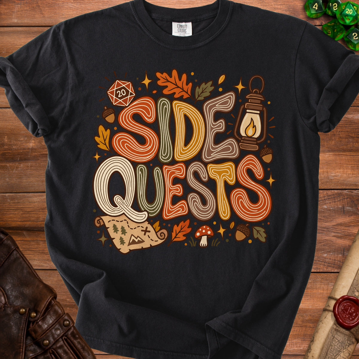 Black t-shirt with "SIDE QUESTS" text, autumn leaves, dice, and map graphics.