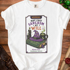 White t-shirt graphic: "Warning: May Cast Sarcasm at Will," a book, and witch hat.