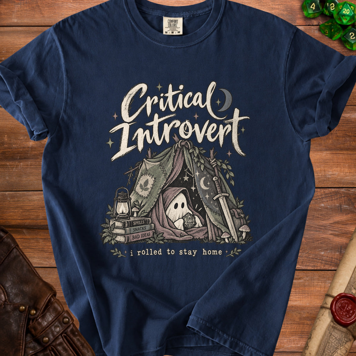 T-shirt graphic: ghost in tent with dice, books, and sword. Text: "Critical Introvert i rolled to stay home".