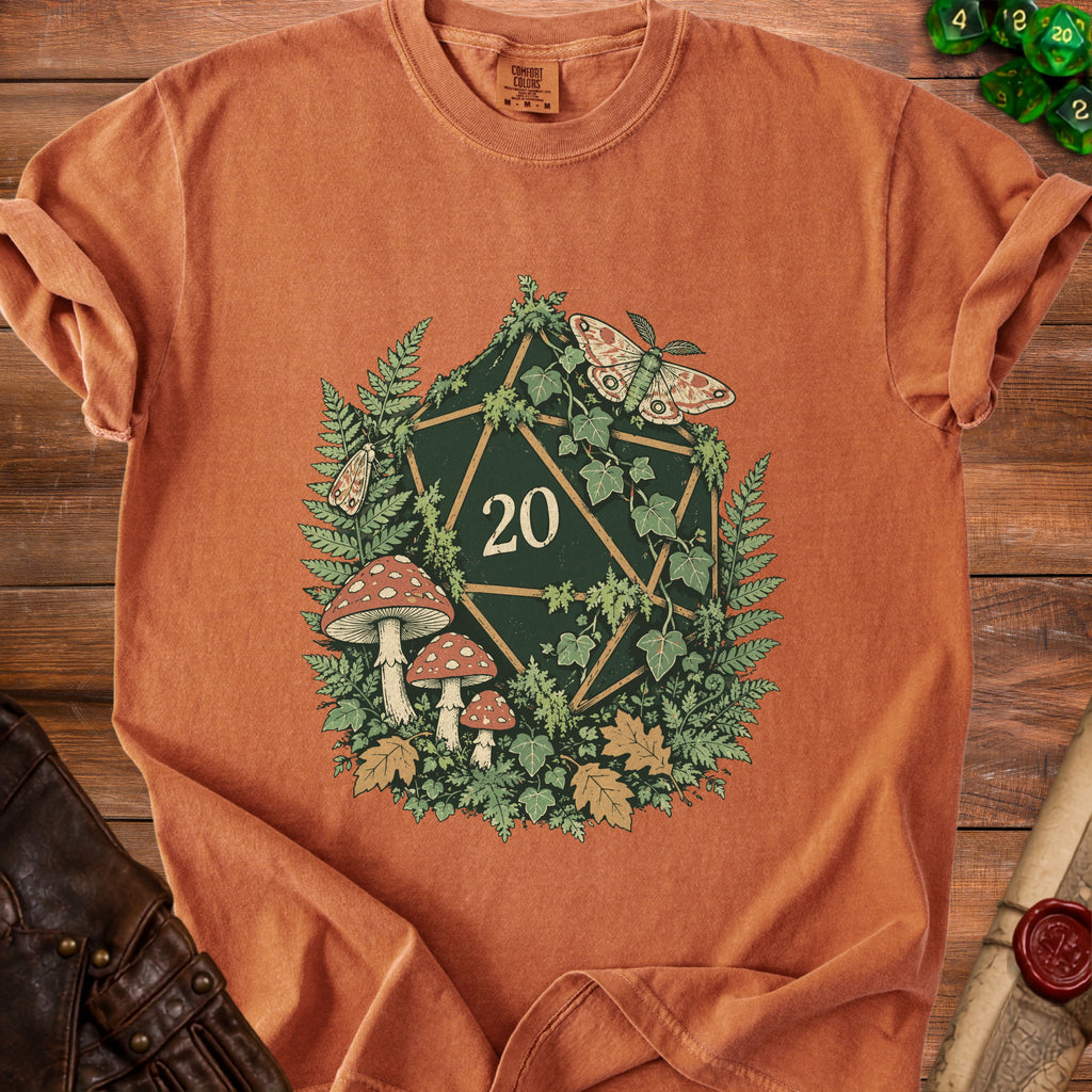 Orange t-shirt with a D20 die design featuring moths, mushrooms, and foliage.