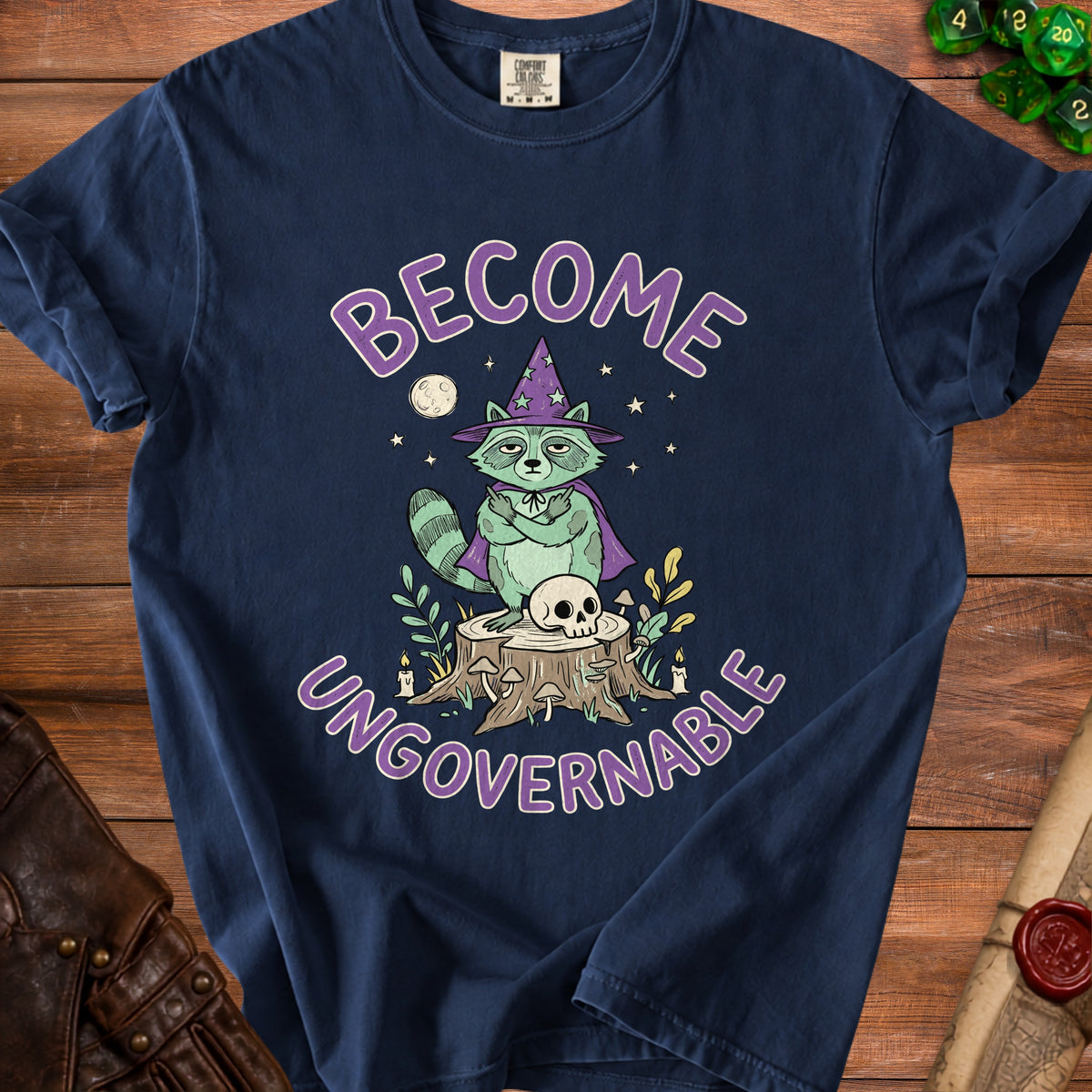 Navy t-shirt with graphic of a raccoon wizard and text "BECOME UNGOVERNABLE".
