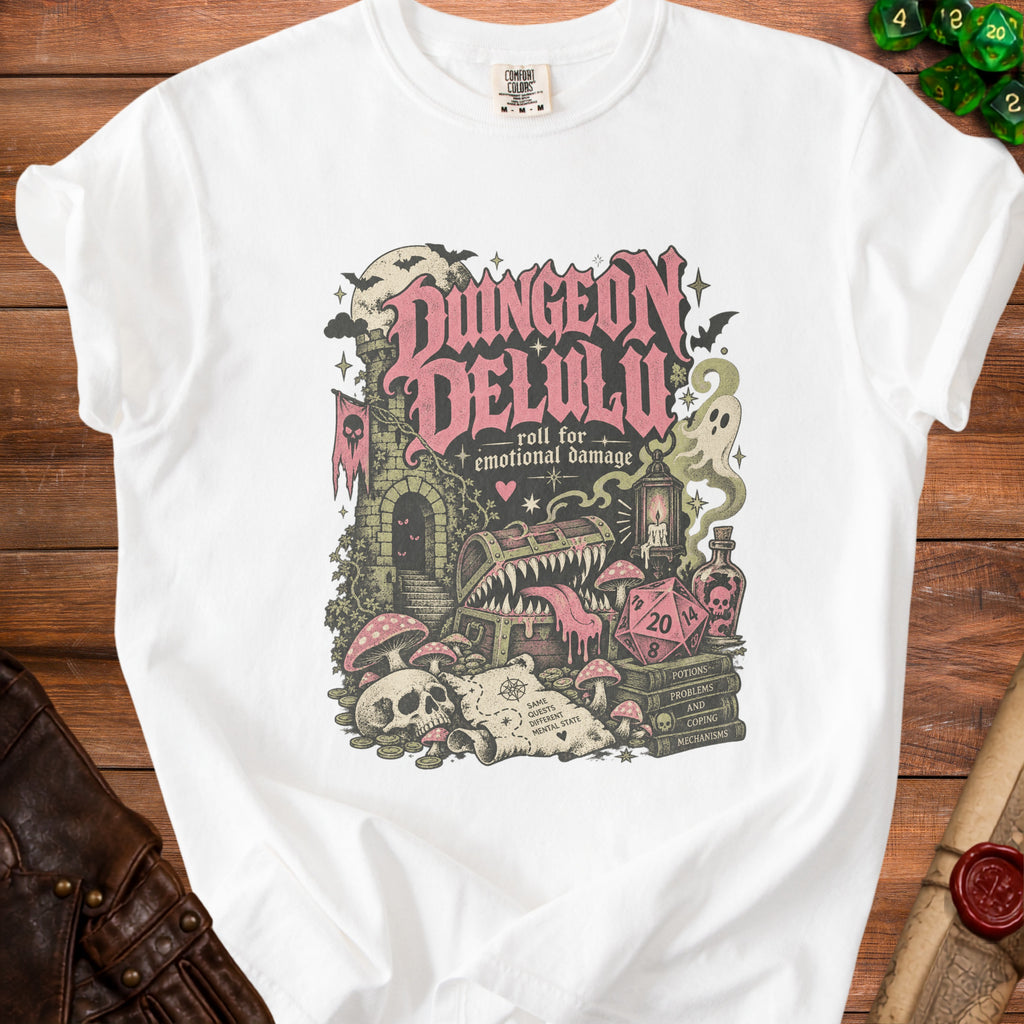 White t-shirt with "Dungeon Delulu" and "roll for emotional damage" text design.