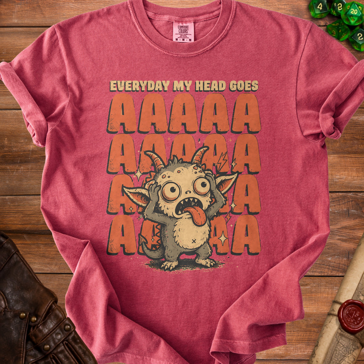 Red t-shirt with a cartoon monster and "EVERYDAY MY HEAD GOES AAAAA" text.