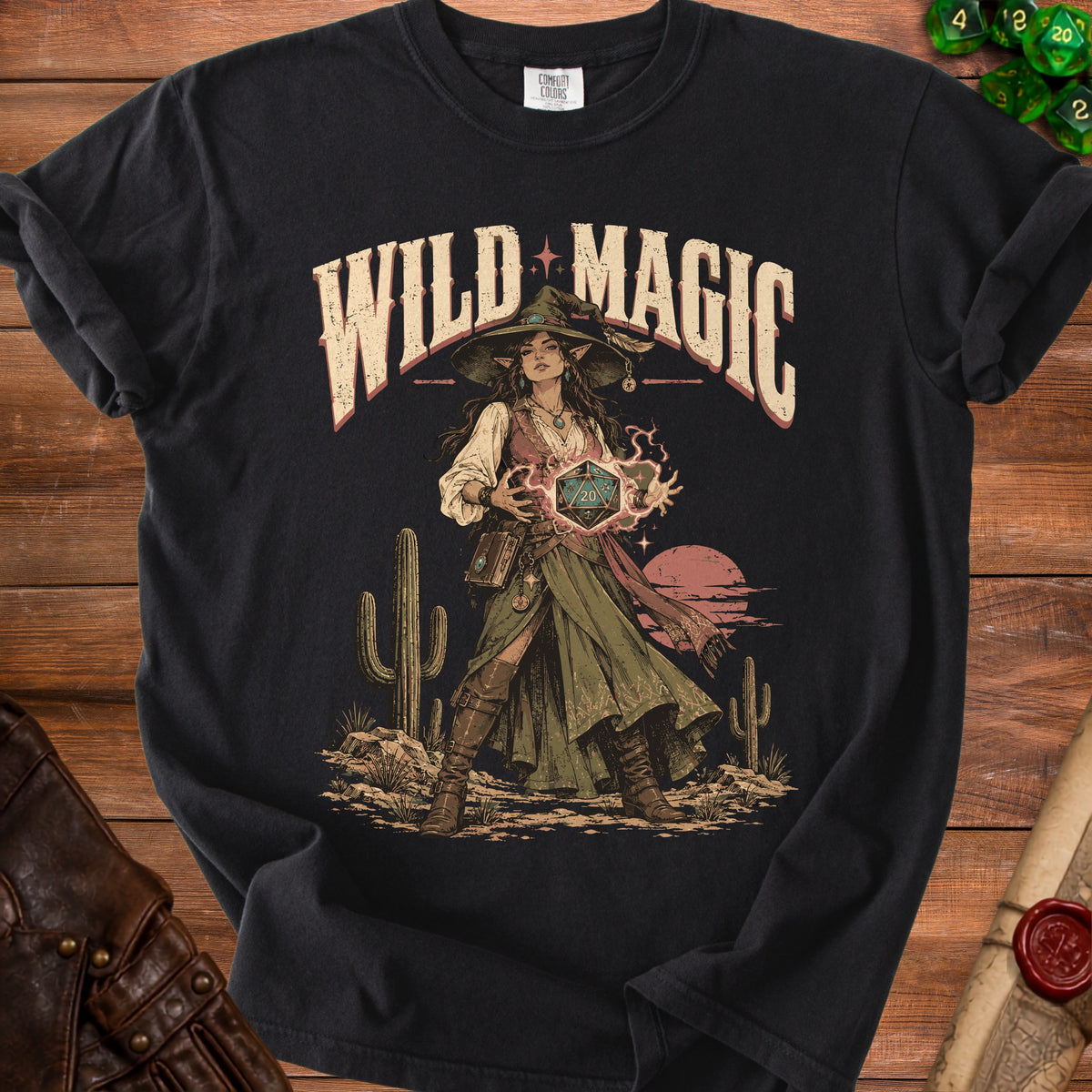Black t-shirt with "Wild Magic" text and a witch holding a d20 die.