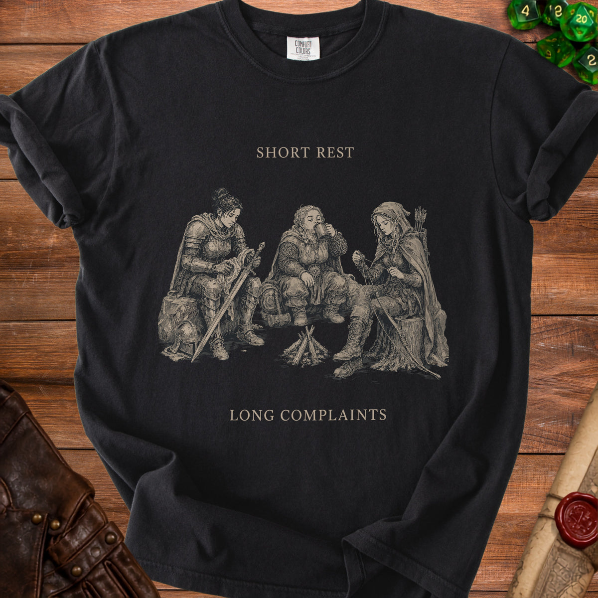 Black t-shirt with drawing of three fantasy characters sitting by a fire, text "SHORT REST" and "LONG COMPLAINTS".