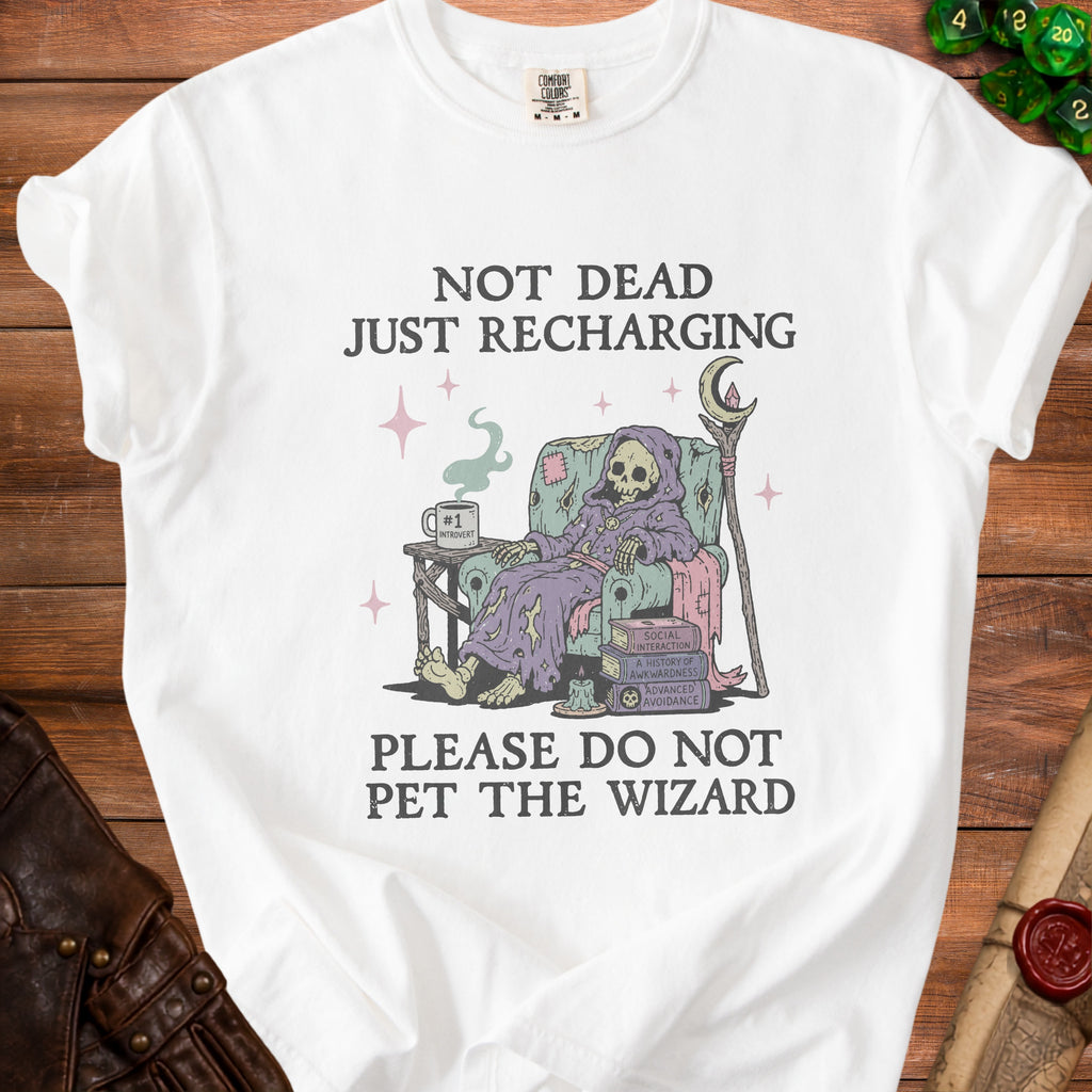 White t-shirt with grim reaper on chair and text "Not Dead Just Recharging. Please Do Not Pet the Wizard."