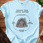 Light blue t-shirt with "Manage Your Social Battery" graphic and cycle diagram.