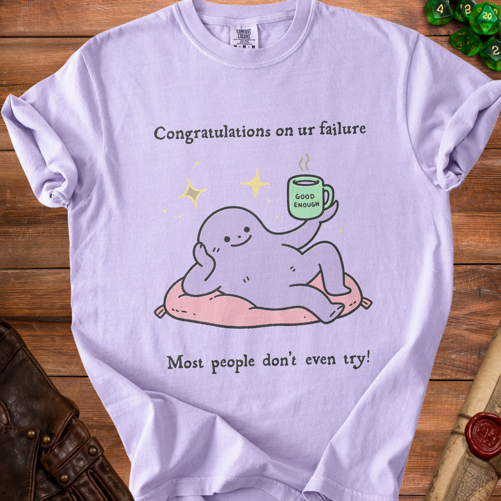 Lavender t-shirt with a cartoon character holding a mug and text about failure.