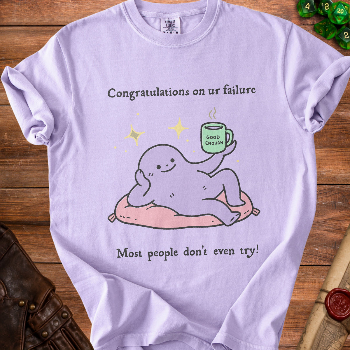 Lavender t-shirt with a cartoon character holding a mug and text about failure.