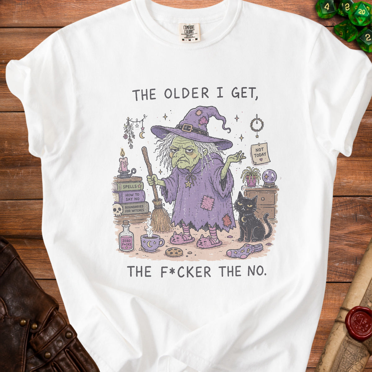 White t-shirt graphic with witch, black cat, books, and text "THE OLDER I GET, THE F*CKER THE NO."