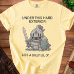 Yellow t-shirt with knight graphic and text "Under this hard exterior lies a silly lil g'".