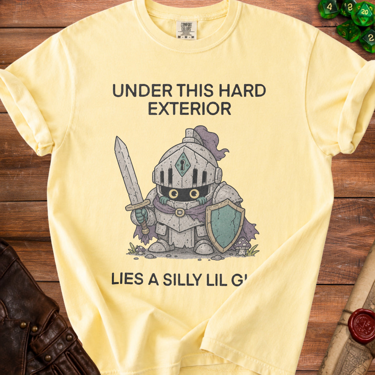 Yellow t-shirt with knight graphic and text "Under this hard exterior lies a silly lil g'".