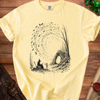 Yellow t-shirt with black graphic of wizard, skeleton, bats, and spooky trees.