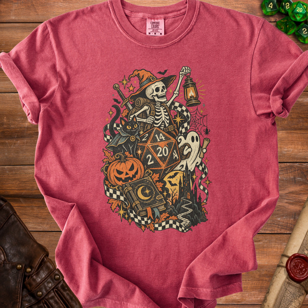 T-shirt featuring Halloween skeleton, black cat, dice, pumpkin, and gothic book illustration.