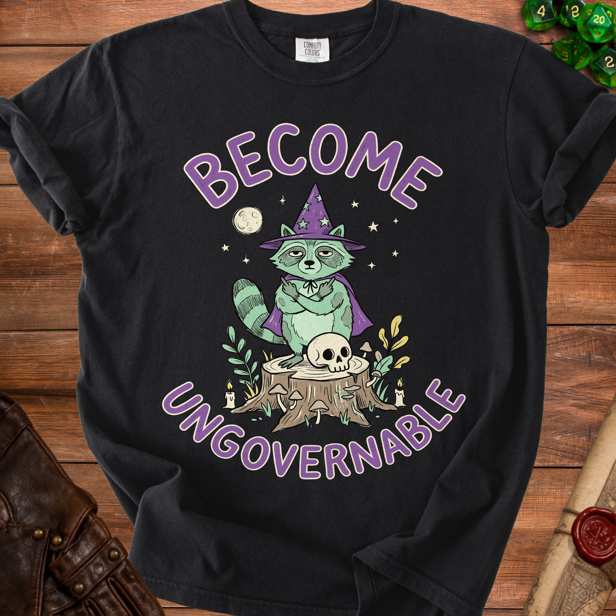 Black t-shirt with a raccoon wizard, skull, and text "BECOME UNGOVERNABLE."