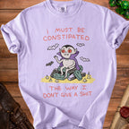 Lavender t-shirt with a cartoon vampire sitting on coffins and text.