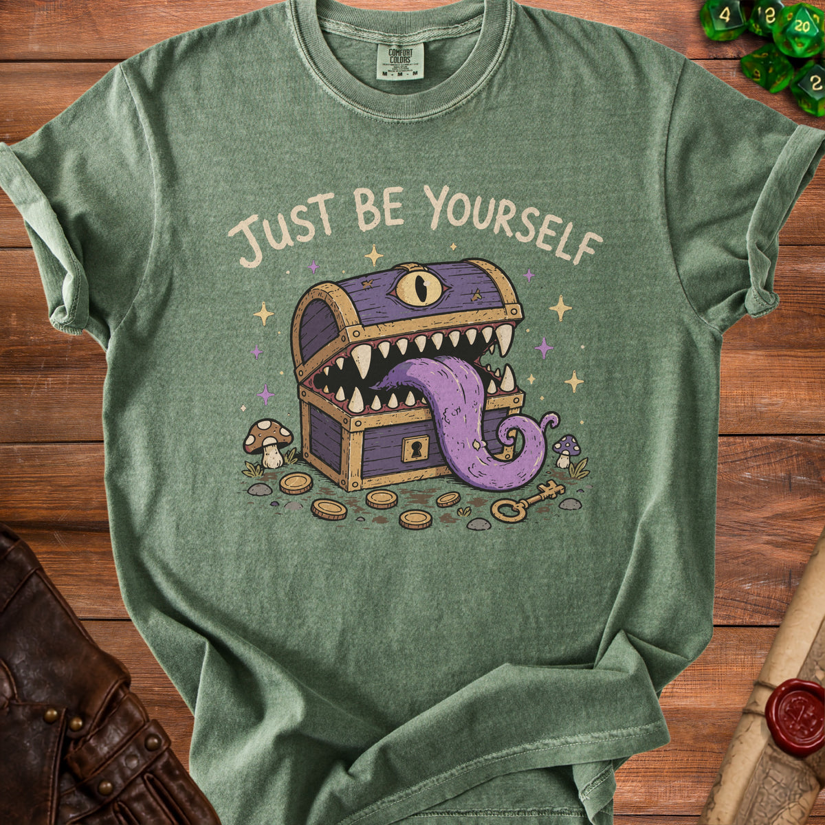 Green t-shirt with "Just Be Yourself" text above a purple monster chest.