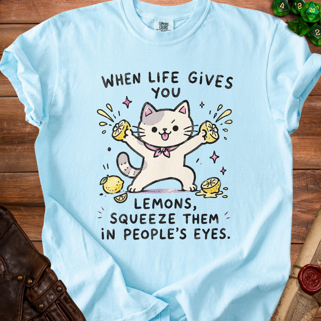 Light blue t-shirt with cartoon cat squeezing lemons and text "When life gives you lemons, squeeze them in people's eyes."