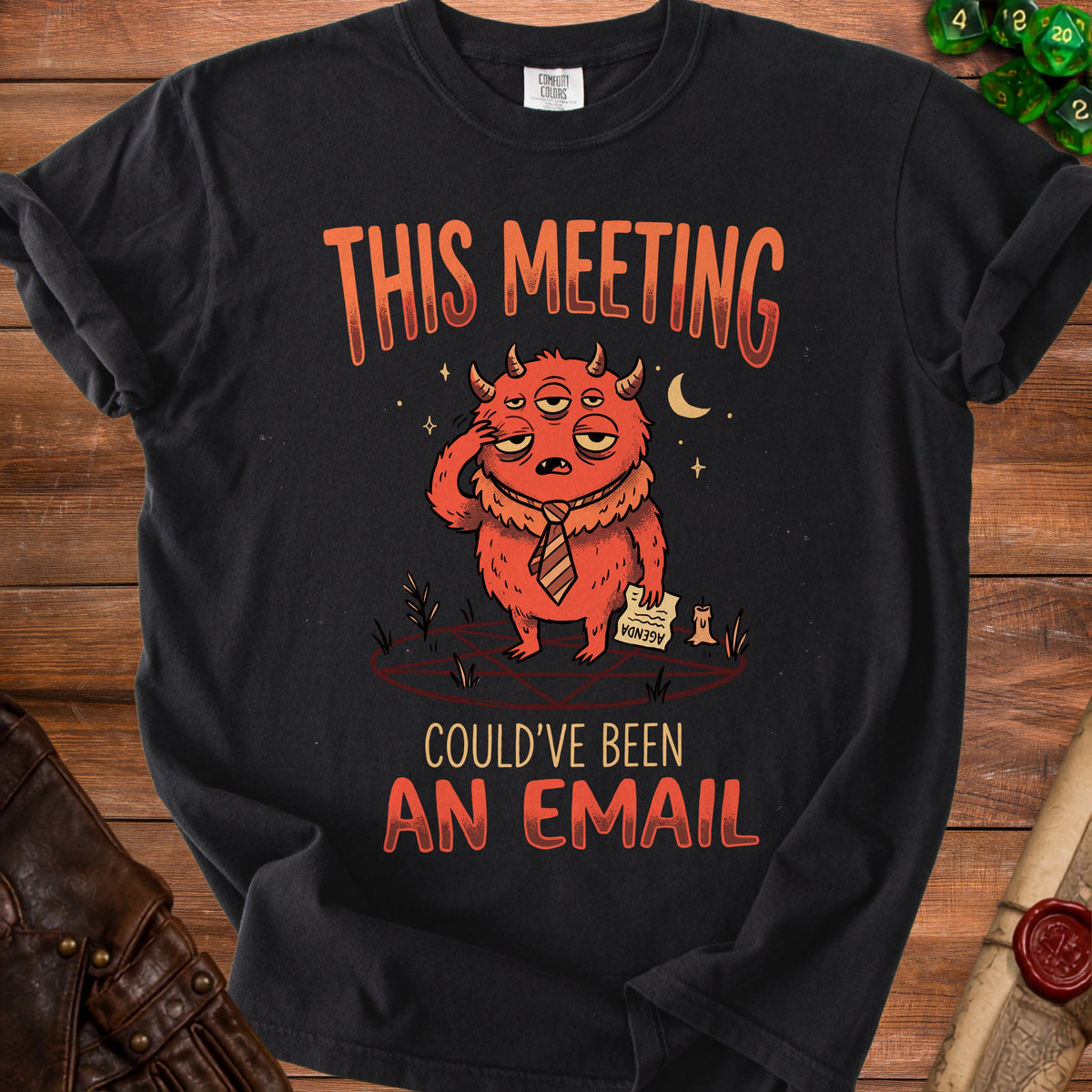 Black t-shirt with a monster graphic and text "THIS MEETING COULD'VE BEEN AN EMAIL".