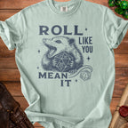 Light blue t-shirt with possum holding dice and text "ROLL LIKE YOU MEAN IT".
