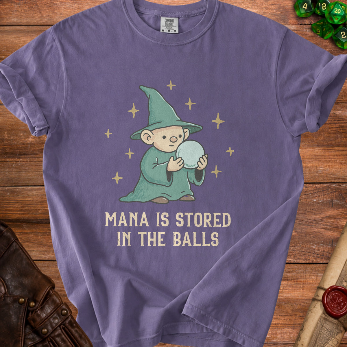 Purple t-shirt with a cartoon wizard holding a ball, text reads "Mana is stored in the balls".
