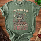 Green t-shirt with a monster graphic and text "MY DOCTOR SAID I'M MORBIDLY A BEAST".