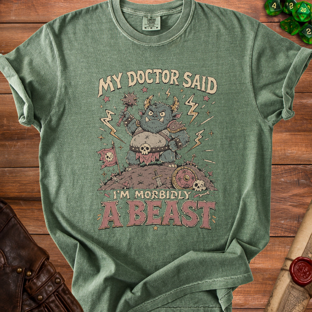 Green t-shirt with a monster graphic and text "MY DOCTOR SAID I'M MORBIDLY A BEAST".