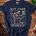 Dark blue t-shirt graphic with knight lifting weights, text "Born to Hunt Forced to Grind".