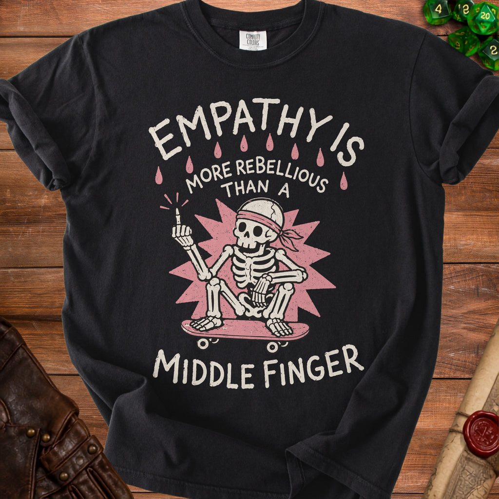 Black t-shirt with skeleton on skateboard saying "Empathy is more rebellious than a middle finger."