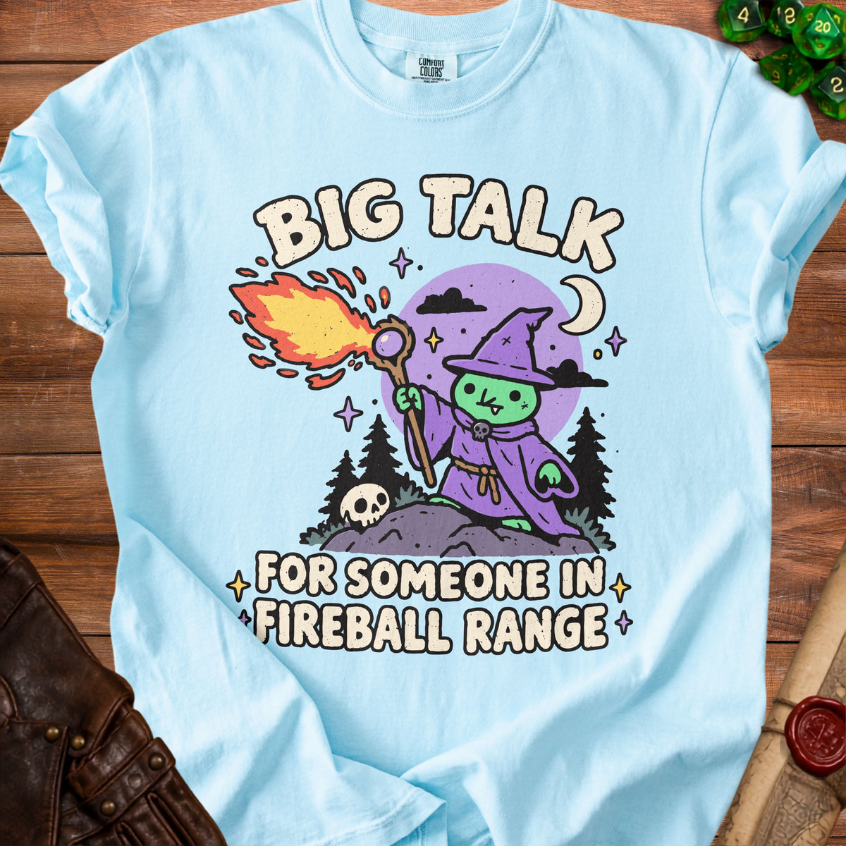 Light blue t-shirt with "Big Talk For Someone In Fireball Range" and a cartoon wizard.
