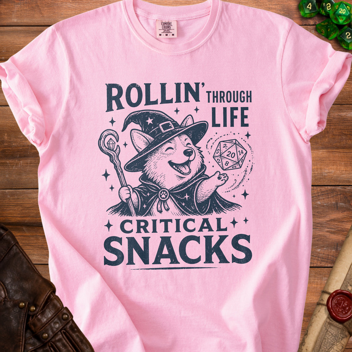 Pink t-shirt with wizard corgi graphic and text "Rollin' Through Life Critical Snacks".