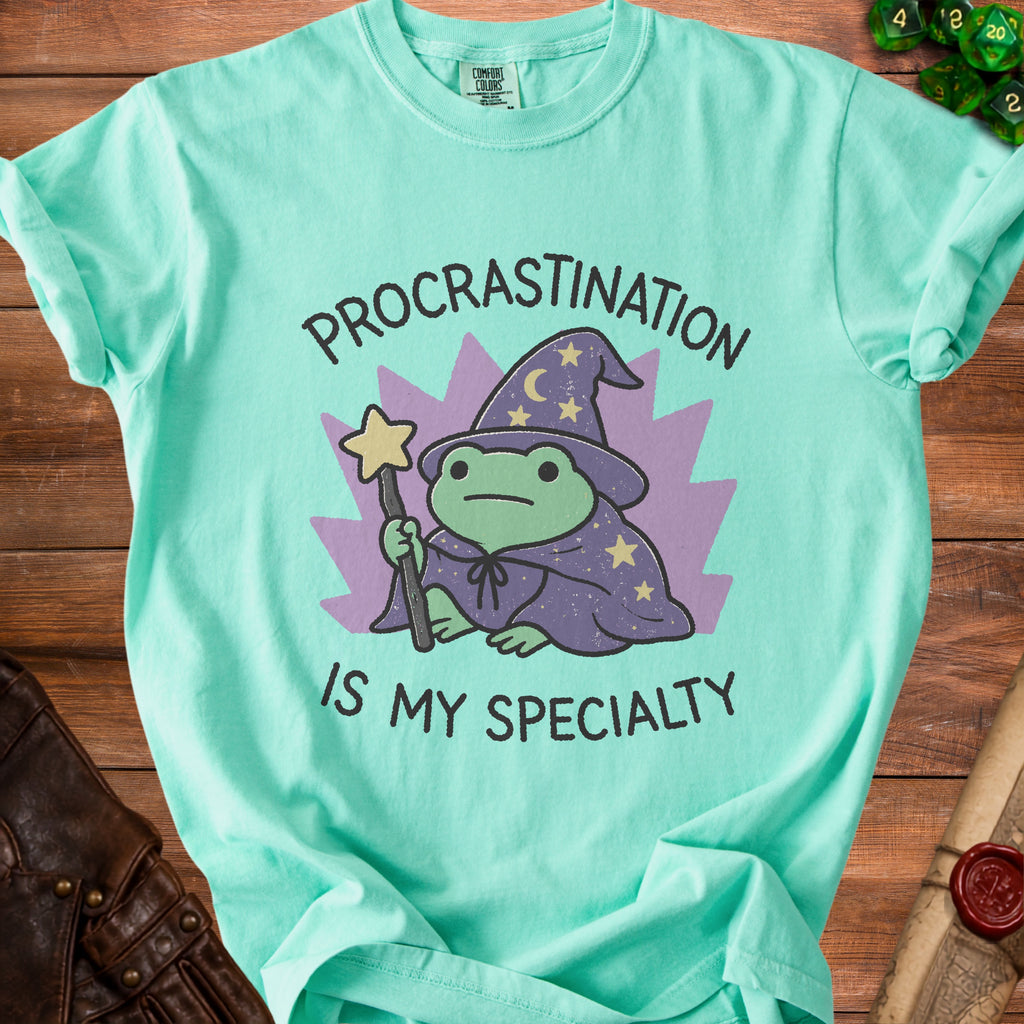 Aqua t-shirt with frog wizard graphic and text "Procrastination is my specialty".