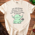 Cream t-shirt with a cartoon alien saying "No revenge because the way your brain is wired is enough."