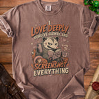 T-shirt with a possum graphic reading "I Love Deeply, Forgive Slowly, and Screenshot Everything."