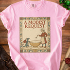 Pink t-shirt with "A Modest Request" text and a medieval-style illustration of a chef and dragon.