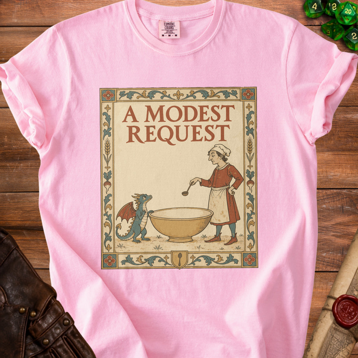 Pink t-shirt with "A Modest Request" text and a medieval-style illustration of a chef and dragon.