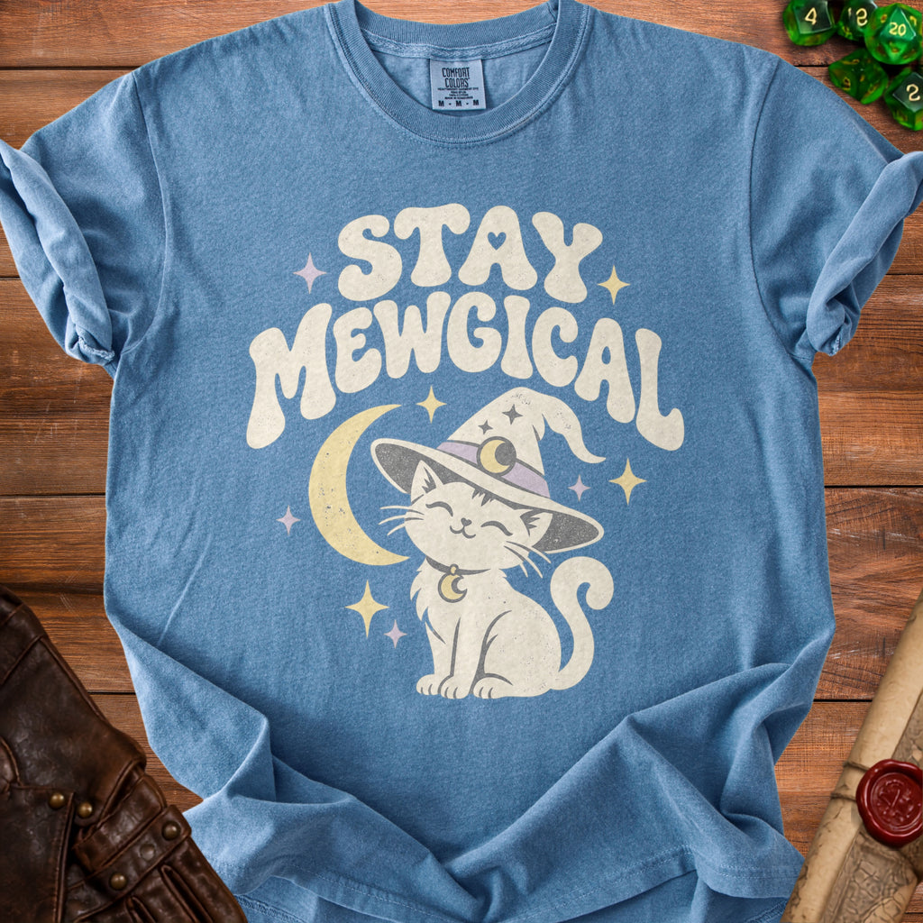 Blue t-shirt with white text "STAY MEWGICAL" and a cartoon cat wearing a witch hat.
