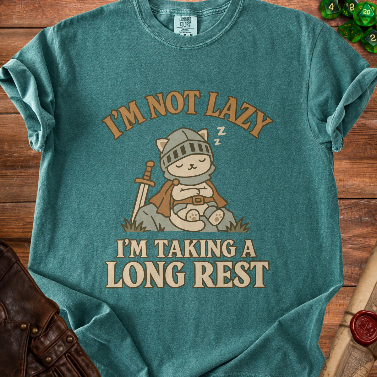 Teal t-shirt with a sleeping knight cat graphic and text "I'M NOT LAZY I'M TAKING A LONG REST".