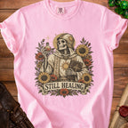 Skeleton in a robe holding a potion and book, with "STILL HEALING" text.